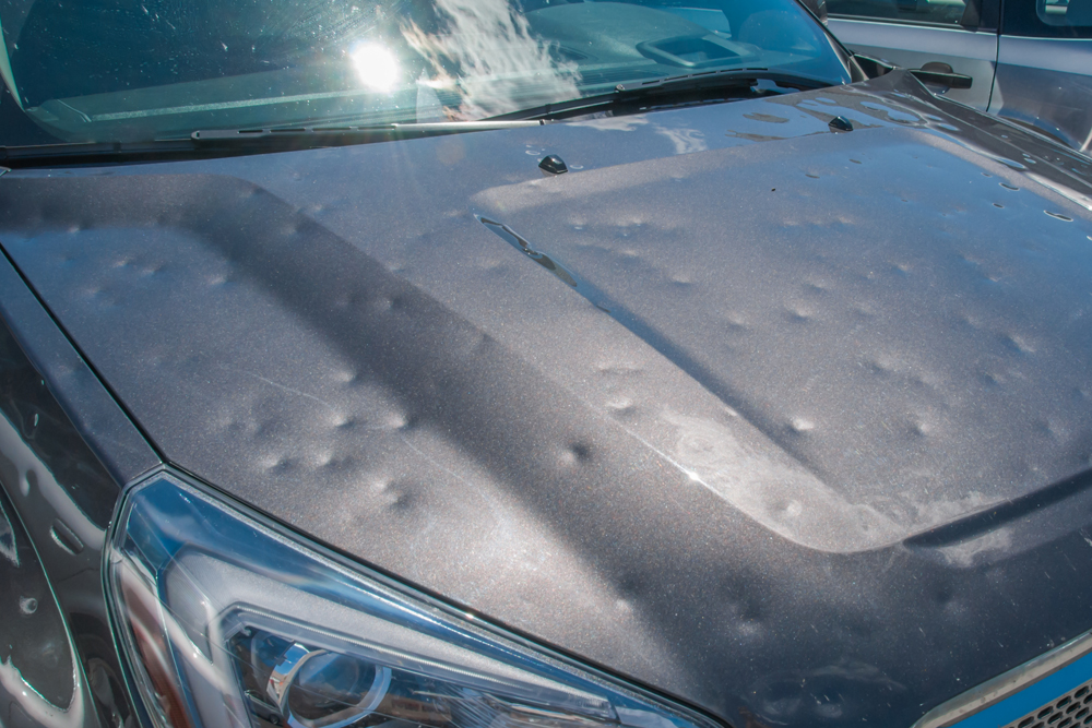 Frozen car windshield covered with ice and snow on a winter day. Close-up view.